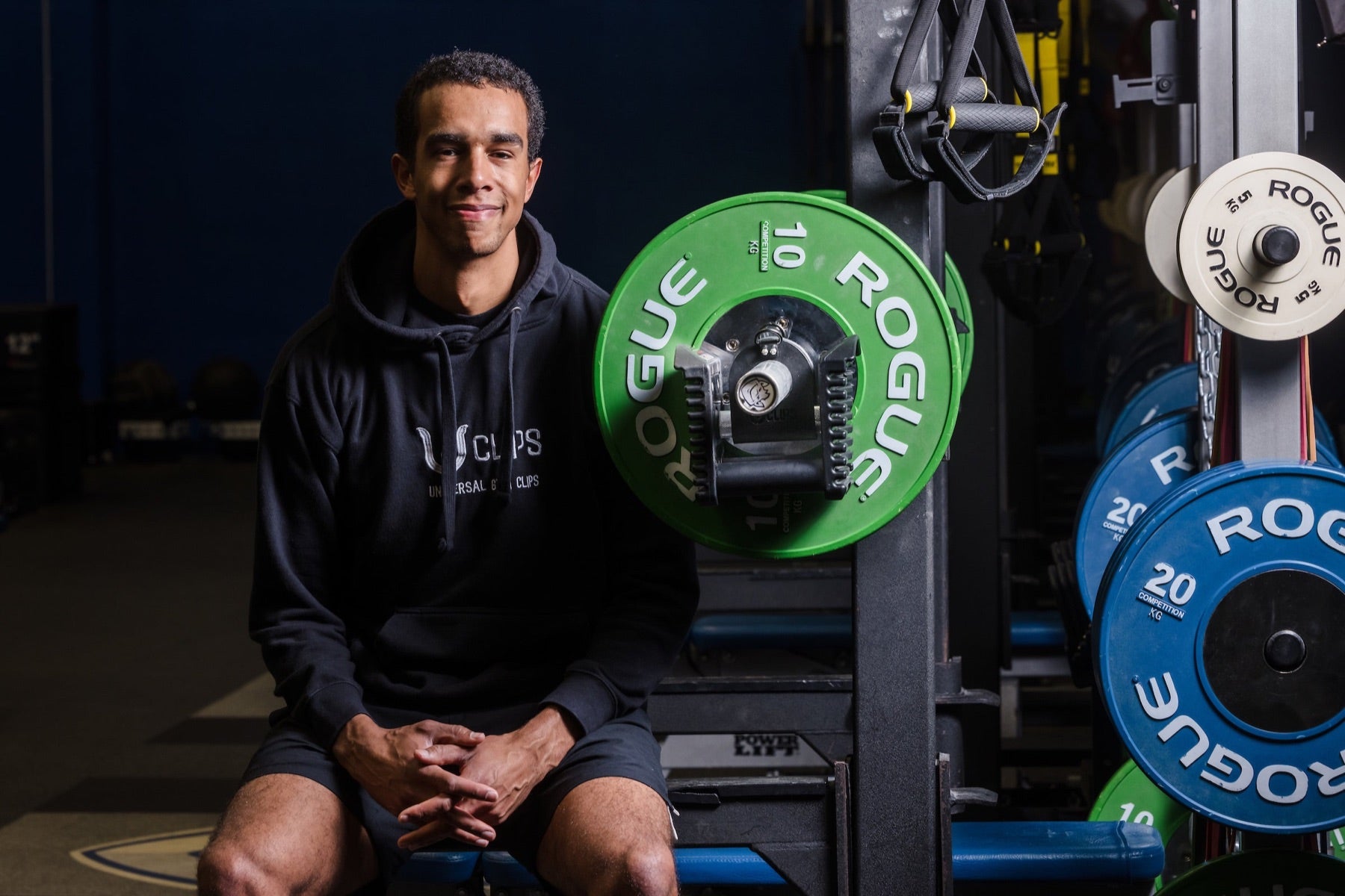 Eliott Ekindi, founder of Uclips, seated in his home gym