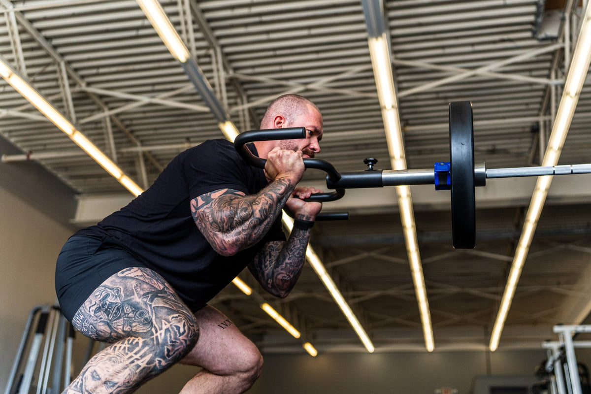 Lifter dialing in the Viking Press angle at a low front-delt position
